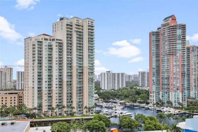 view of building exterior with a view of city and a water view