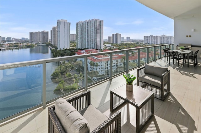 balcony featuring a city view and a water view