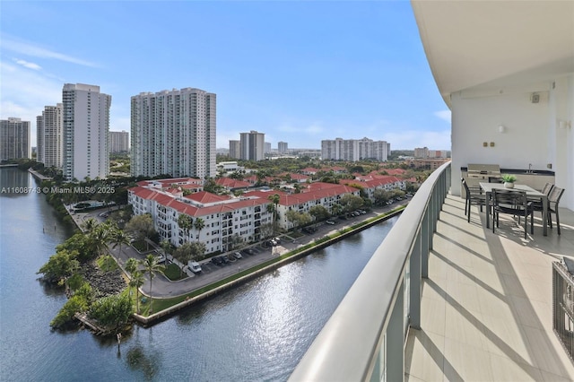 balcony featuring a water view and a city view