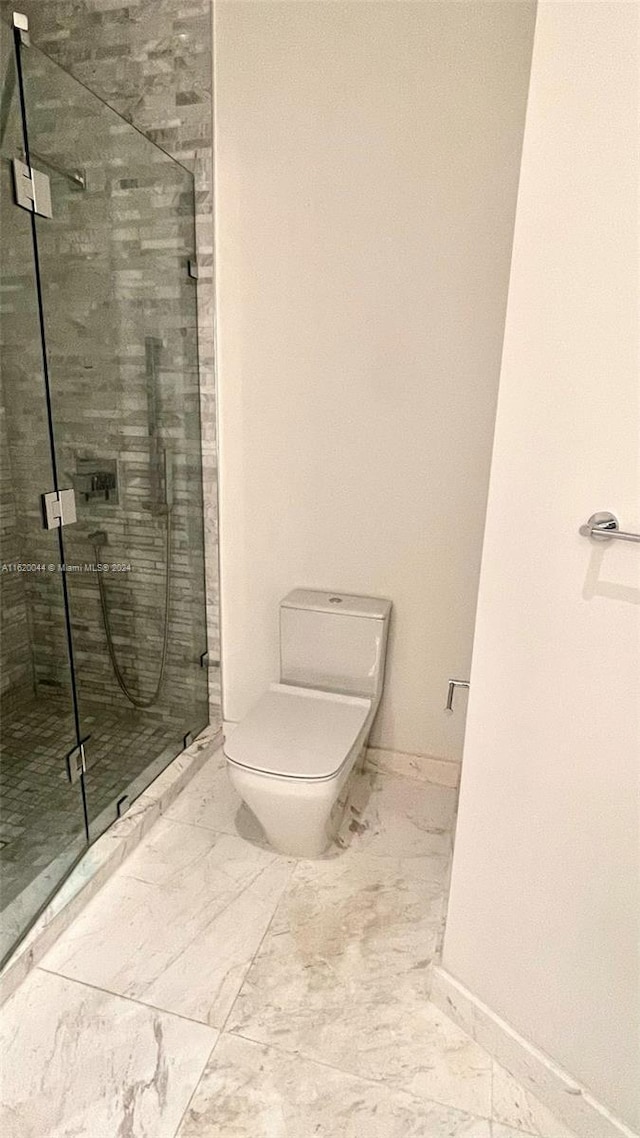 bathroom featuring toilet and walk in shower