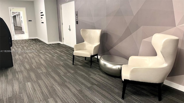 living area with dark colored carpet