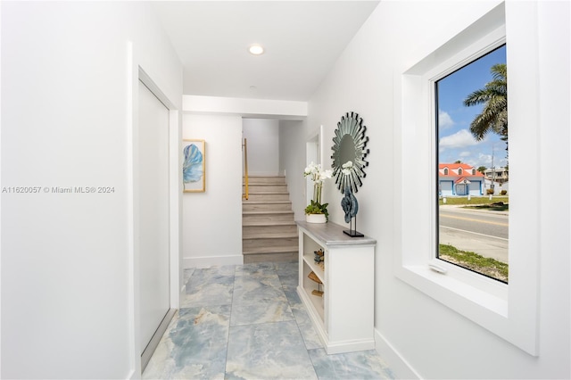 hall with light tile patterned floors