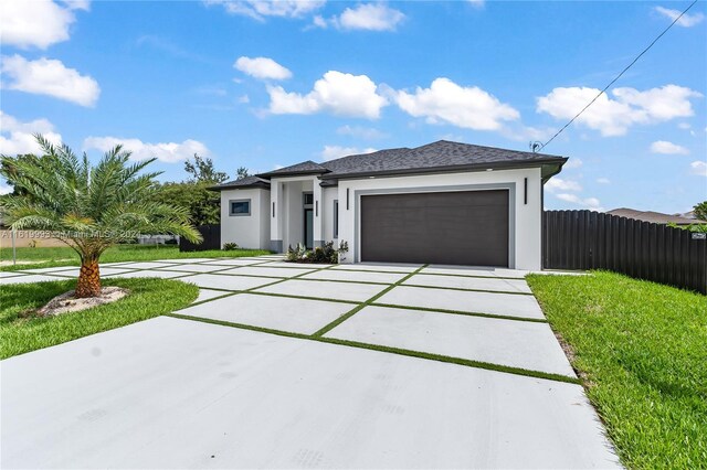 view of front of property featuring a garage and a front yard