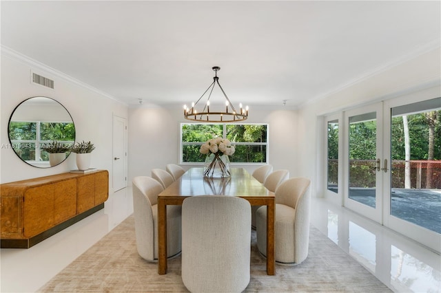 dining area featuring french doors, a notable chandelier, and ornamental molding