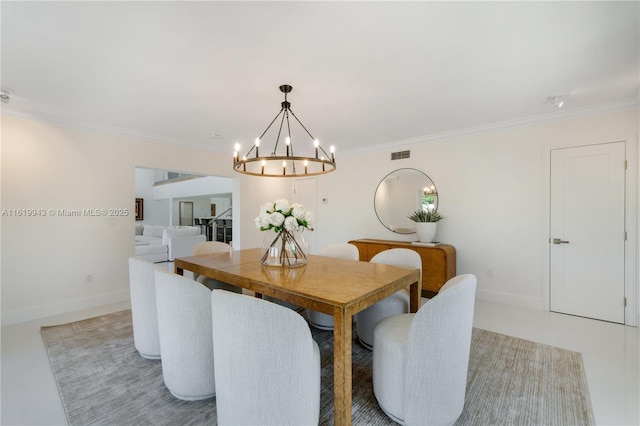 tiled dining room featuring an inviting chandelier and ornamental molding