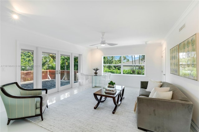 living room with ceiling fan, crown molding, and french doors