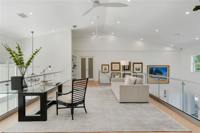 interior space featuring lofted ceiling and light wood-type flooring