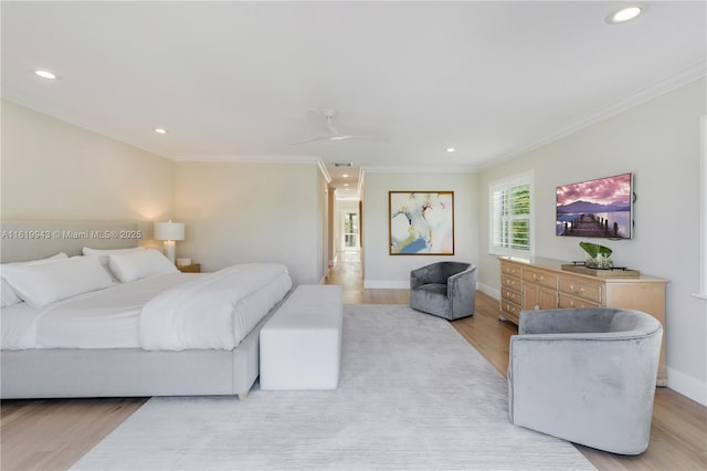 bedroom with light hardwood / wood-style floors, crown molding, and ceiling fan