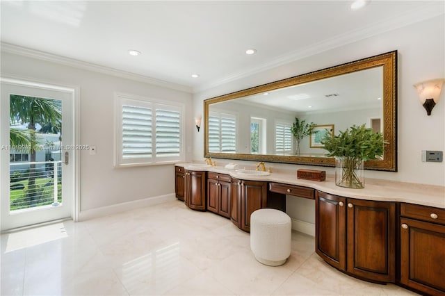 bathroom with a wealth of natural light, vanity, and ornamental molding