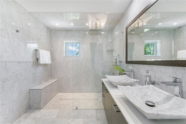 bathroom with tile walls, plenty of natural light, and a tile shower