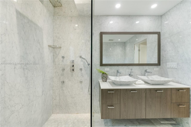 bathroom featuring tiled shower and vanity