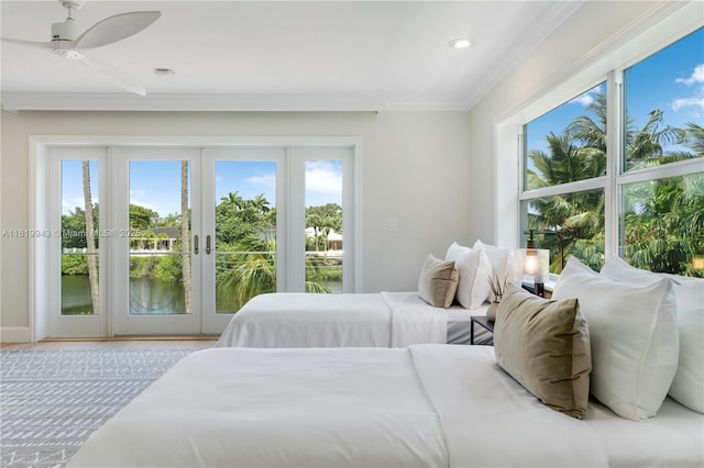 bedroom featuring ceiling fan, access to exterior, multiple windows, and ornamental molding