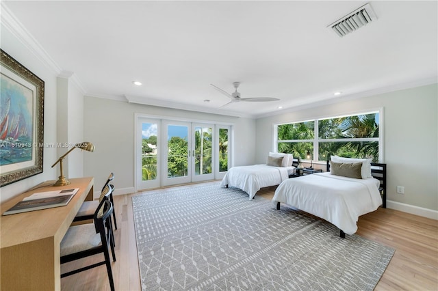 bedroom featuring ceiling fan, multiple windows, and ornamental molding