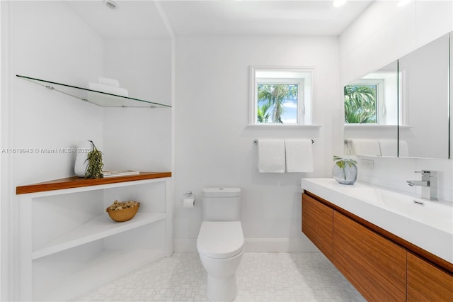 bathroom featuring toilet and vanity