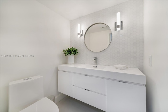 bathroom featuring toilet and vanity