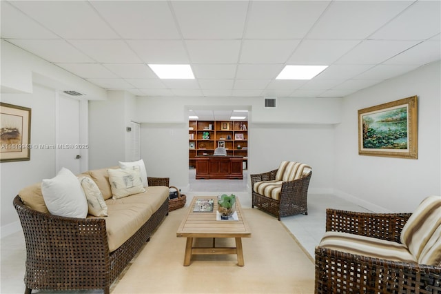 living room with a drop ceiling