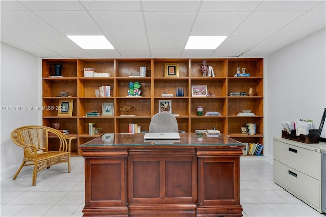 office area with built in features and a drop ceiling