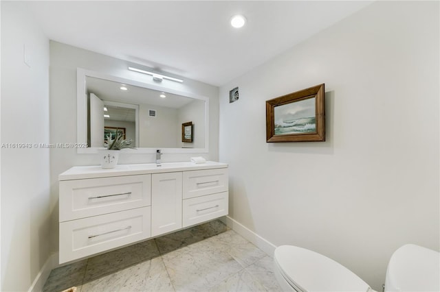 bathroom featuring toilet and vanity