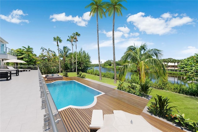 view of pool with a patio area, a jacuzzi, a yard, and a water view