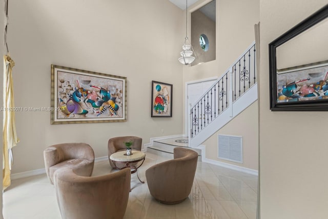 living room featuring a high ceiling and tile patterned flooring