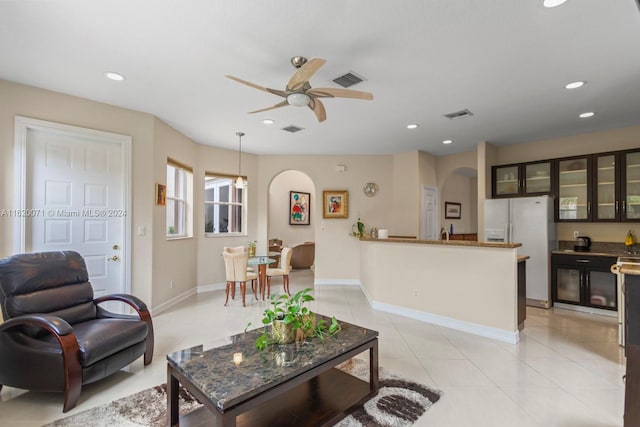 tiled living room featuring ceiling fan