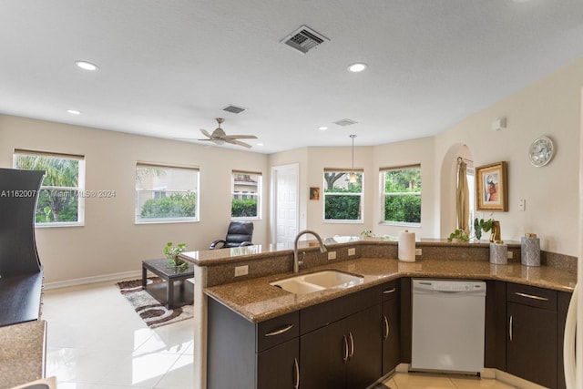 kitchen featuring sink, dishwasher, a wealth of natural light, and light tile patterned floors