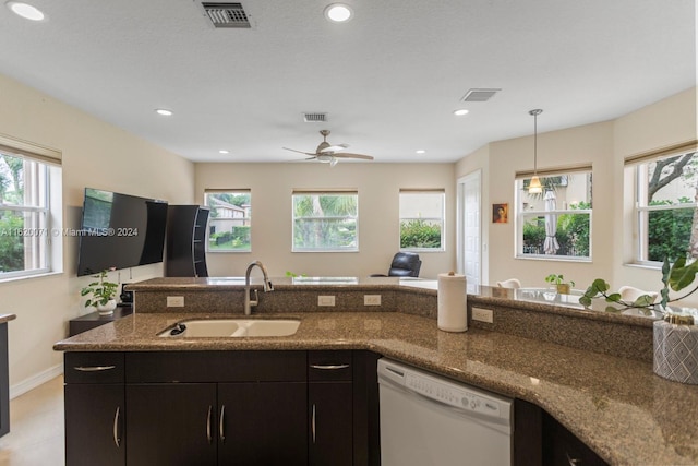 kitchen featuring a wealth of natural light, sink, ceiling fan, and white dishwasher