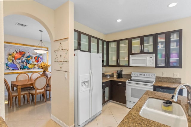 kitchen featuring light tile patterned flooring, hanging light fixtures, white appliances, and sink