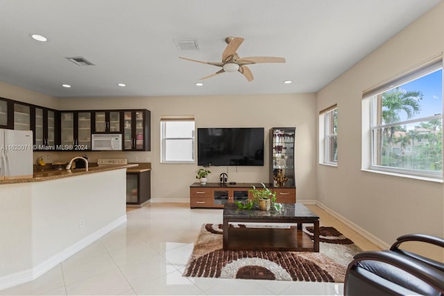 tiled living room featuring ceiling fan