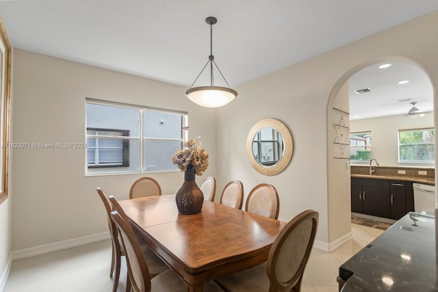 tiled dining space featuring sink and ceiling fan