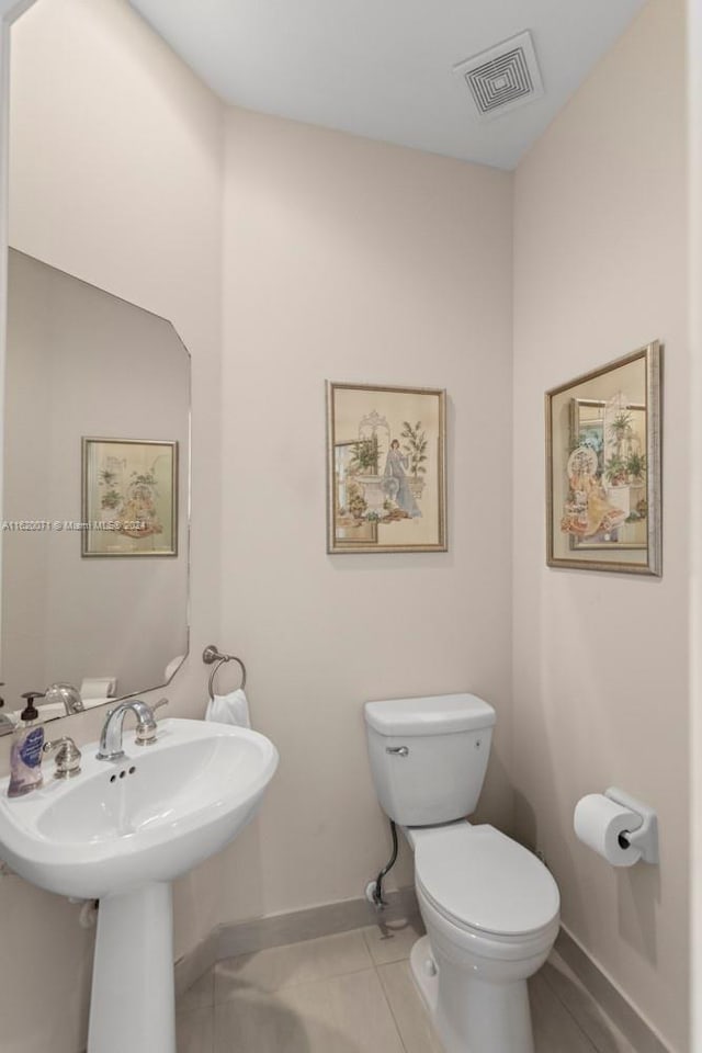 bathroom featuring toilet and tile patterned flooring