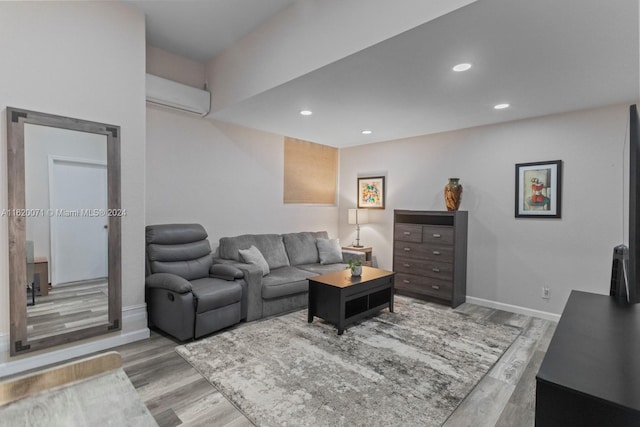 living room with wood-type flooring and a wall mounted air conditioner