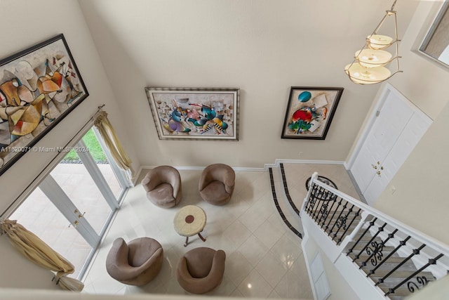 interior space with a high ceiling and tile patterned flooring