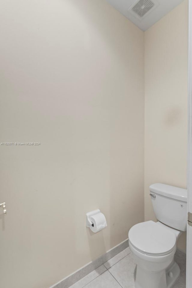 bathroom featuring tile patterned flooring and toilet