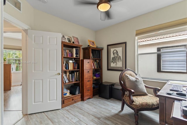 home office featuring light hardwood / wood-style floors and ceiling fan