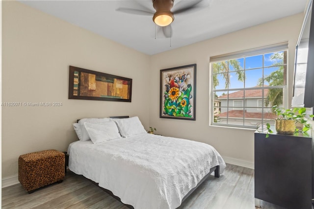 bedroom with ceiling fan and wood-type flooring