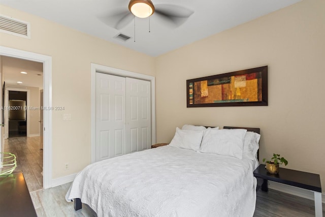 bedroom with a closet, wood-type flooring, and ceiling fan