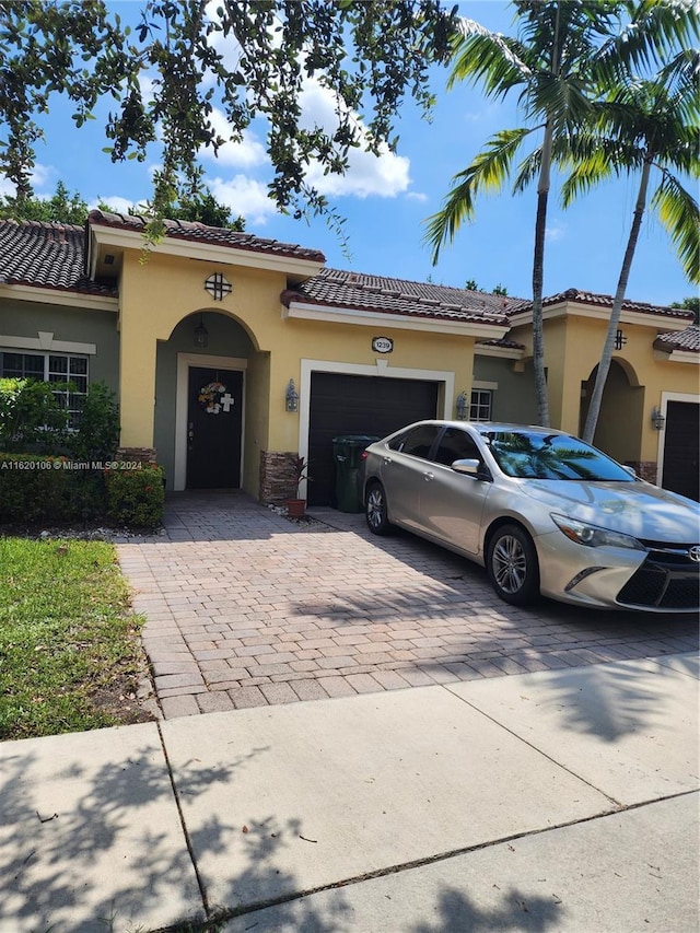 mediterranean / spanish home featuring a garage