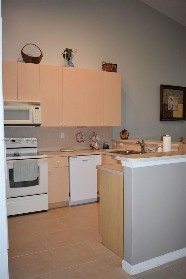 kitchen featuring decorative backsplash, sink, white appliances, and light tile patterned floors