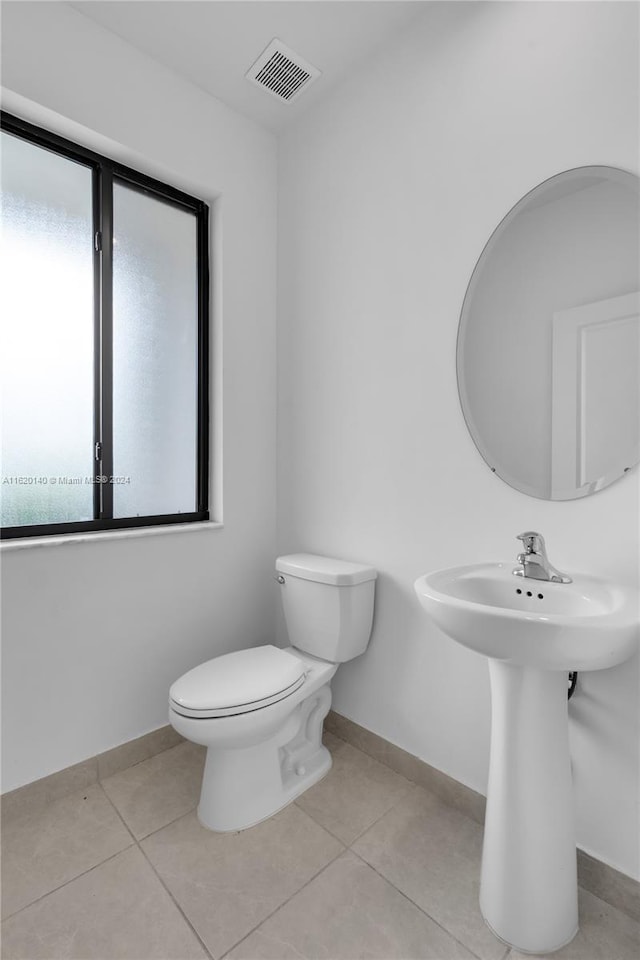 bathroom featuring sink, toilet, and tile patterned flooring