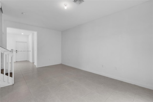 spare room featuring light tile patterned floors