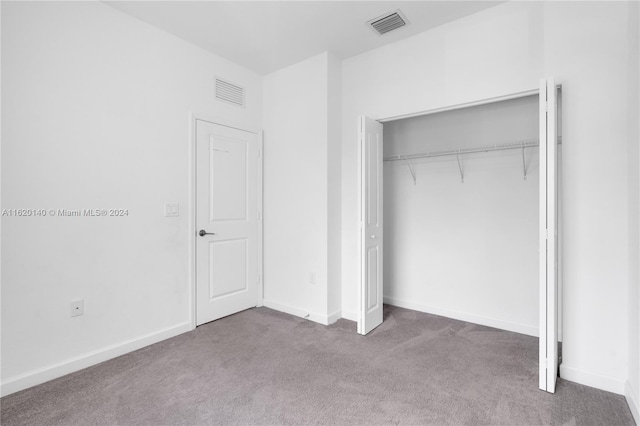 unfurnished bedroom featuring a closet and carpet floors