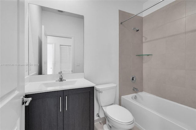 full bathroom with toilet, tiled shower / bath combo, and vanity