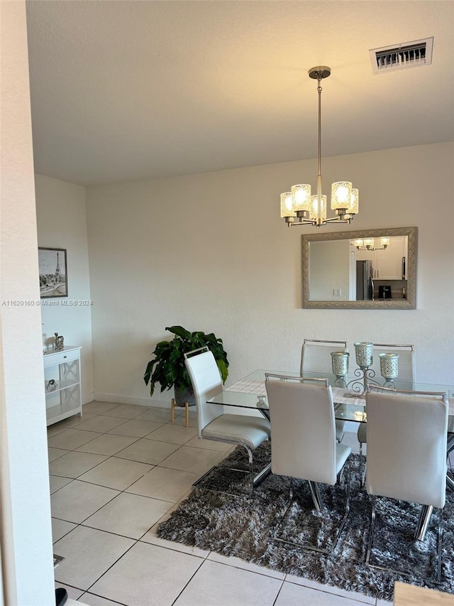 tiled dining area with a notable chandelier