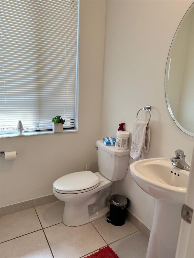 bathroom with toilet and tile patterned flooring