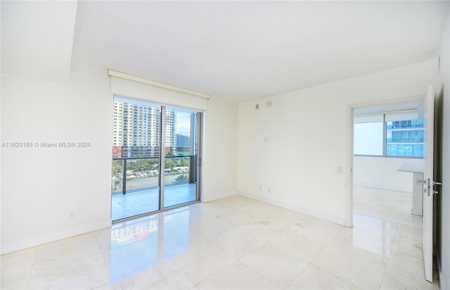 unfurnished room featuring light tile patterned floors