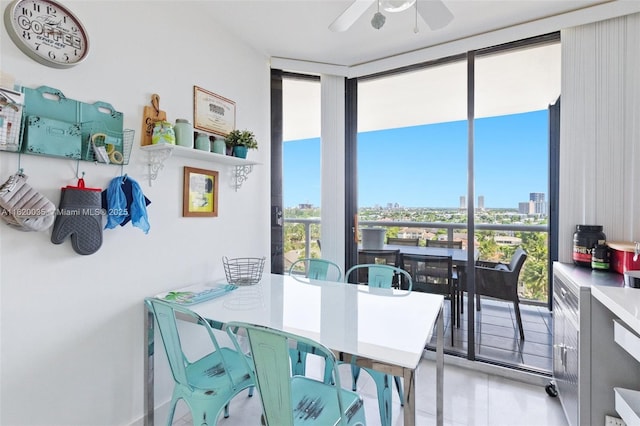 dining room featuring expansive windows and ceiling fan