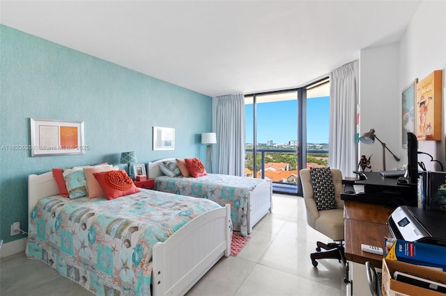 tiled bedroom featuring a wall of windows and access to outside