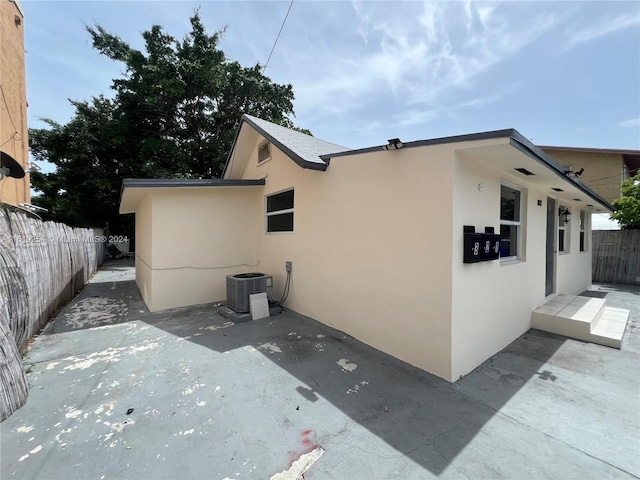 view of home's exterior featuring central AC and a patio