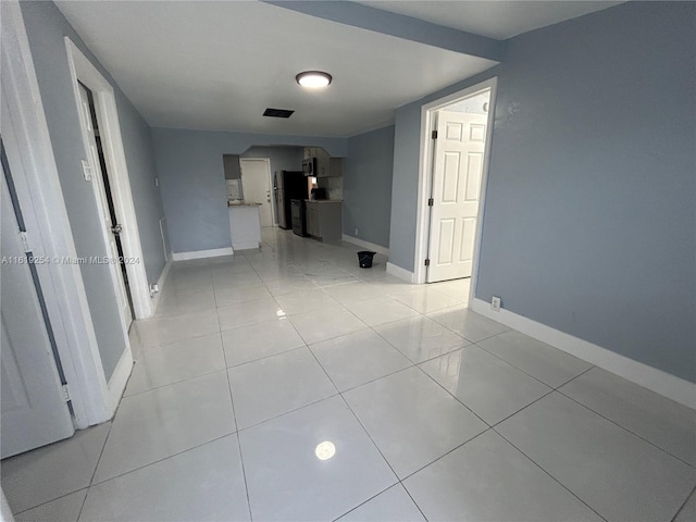 hall with light tile patterned flooring